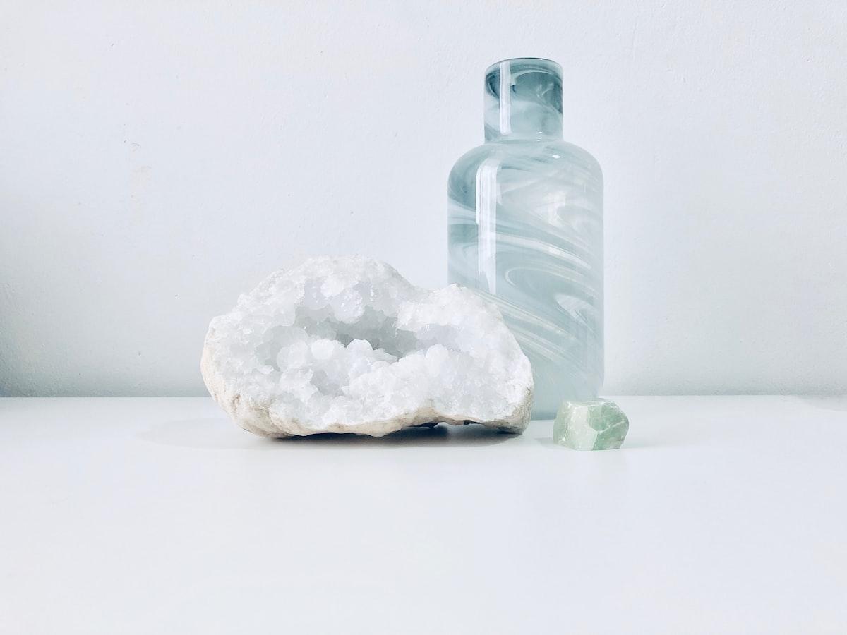 A geode held in soft light — raw stone, quiet surface